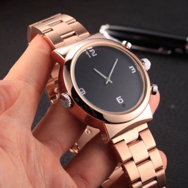 Ladies & Mens HD 1080P watch spy camera gold band being hand held